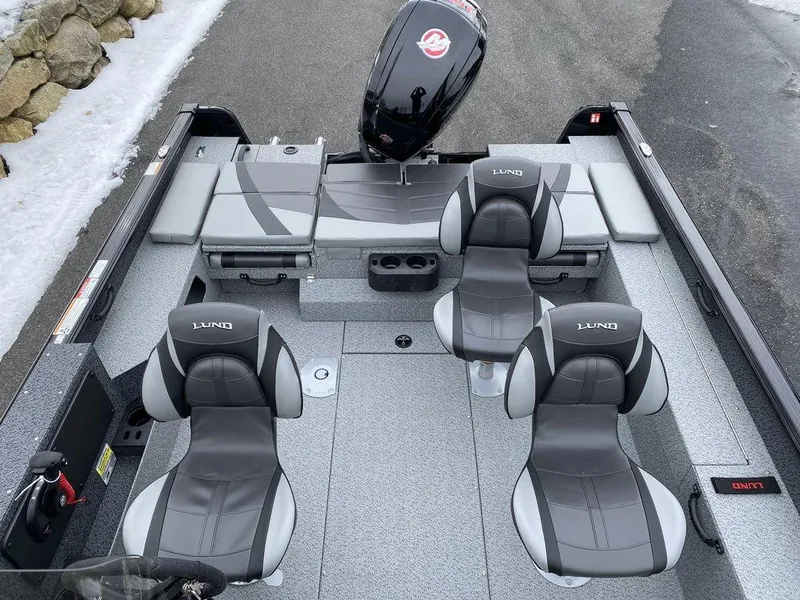 Slide: The Image of 2025 Lund 1775 Impact XS SS boat interior with four seats and motor. - 12