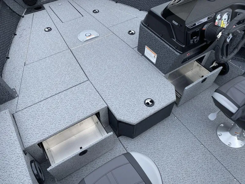 Slide: The Image of 2025 Lund 1775 Impact XS SS boat interior with storage compartments and steering console. - 16