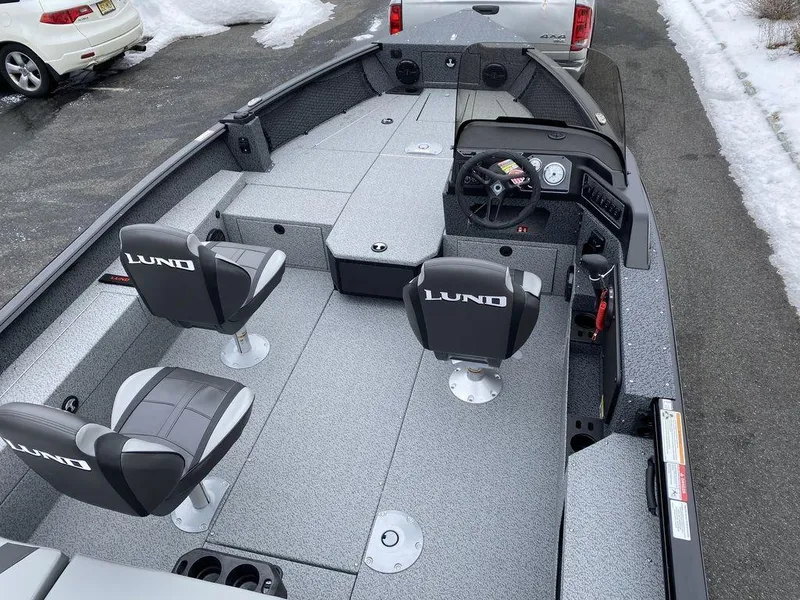 Slide: The Image of 2025 Lund 1775 Impact XS SS boat interior with two seats and steering console. - 6