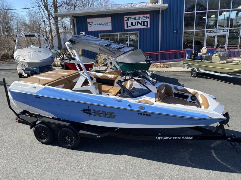 The Image of 2025 Axis A20 boat on trailer, parked outside marine dealership. - 0