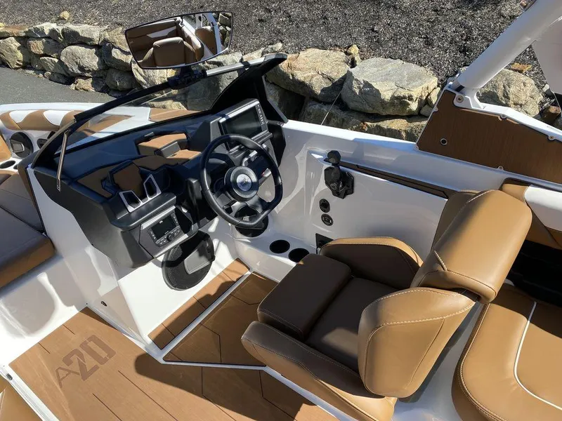 Slide: The Image of 2025 Axis A20 boat interior with brown seats and modern dashboard. - 6
