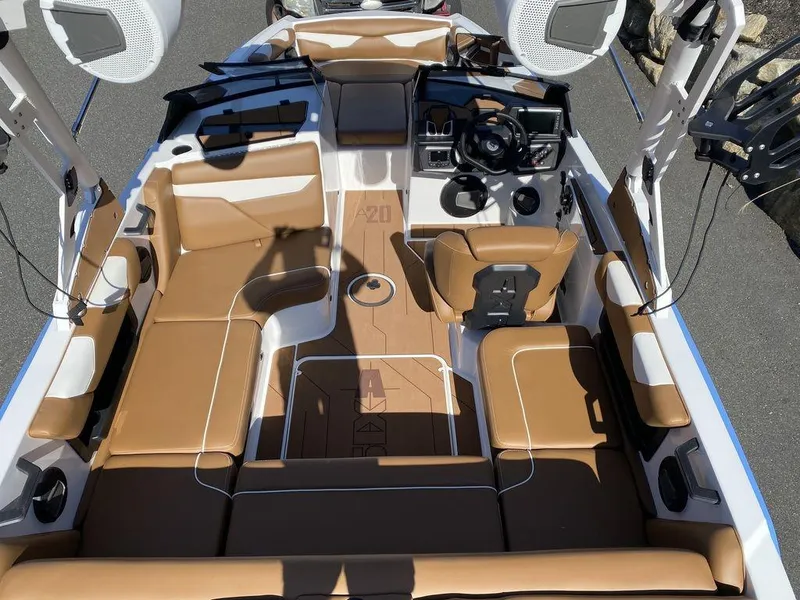 Slide: The Image of 2025 Axis A20 boat interior with tan seating and modern dashboard. - 7