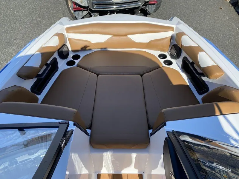 Slide: The Image of 2025 Axis A20 boat interior with brown and white seating, cup holders, and sleek design. - 9