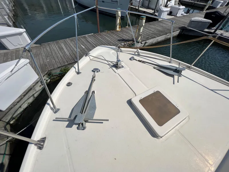 Slide: The Image of 1967 Hatteras 41 Twin Cabin boat deck with anchors at marina. - 13