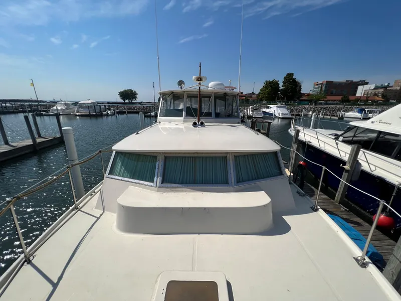Slide: The Image of 1967 Hatteras 41 Twin Cabin yacht docked at marina under clear blue sky. - 14