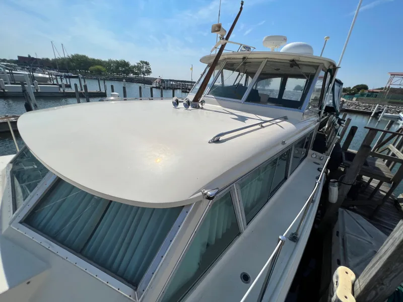 Slide: The Image of 1967 Hatteras 41 Twin Cabin yacht docked at marina under clear blue sky. - 15