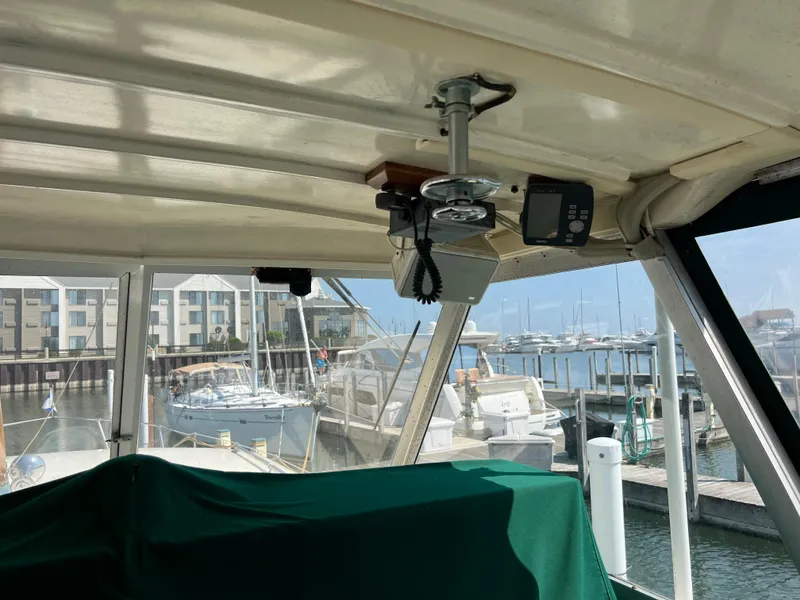 Slide: The Image of Interior view of 1967 Hatteras 41 Twin Cabin at marina, featuring navigation equipment. - 17