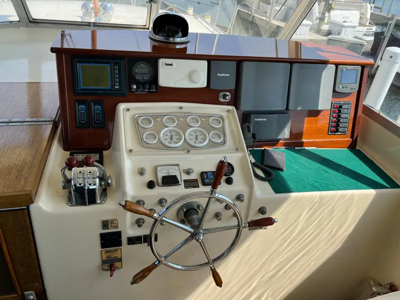 Slide: The Image of 1967 Hatteras 41 Twin Cabin helm with vintage gauges and controls. - 19