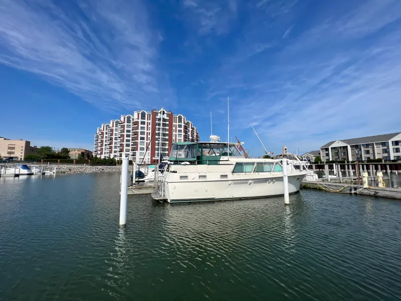 Slide: The Image of 1967 Hatteras 41 Twin Cabin yacht docked in marina, clear blue sky. - 2