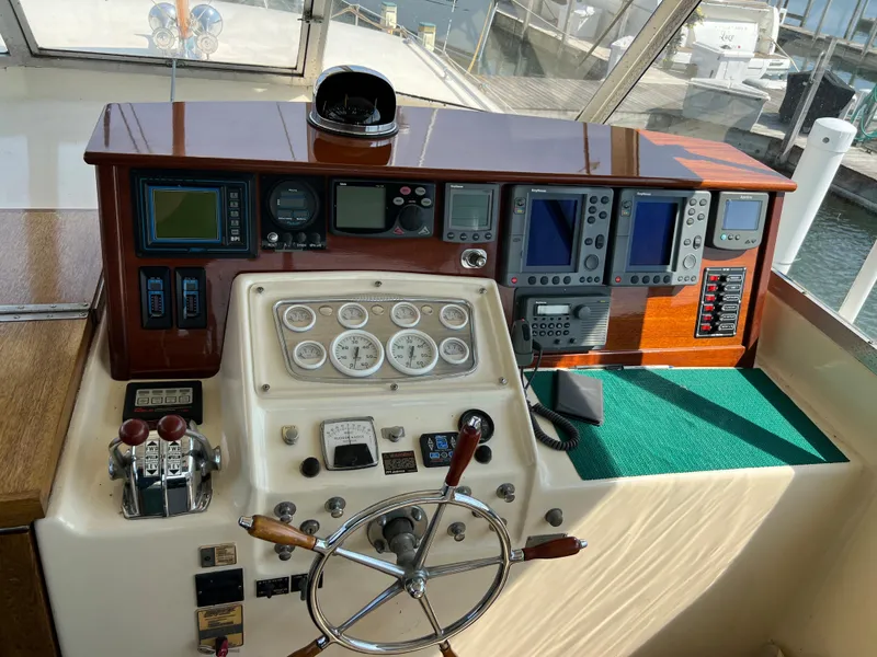 Slide: The Image of 1967 Hatteras 41 Twin Cabin helm with vintage gauges and modern navigation equipment. - 20