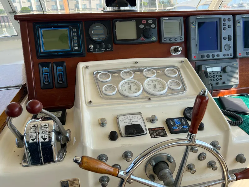 Slide: The Image of Vintage 1967 Hatteras 41 Twin Cabin helm with classic gauges and controls. - 21