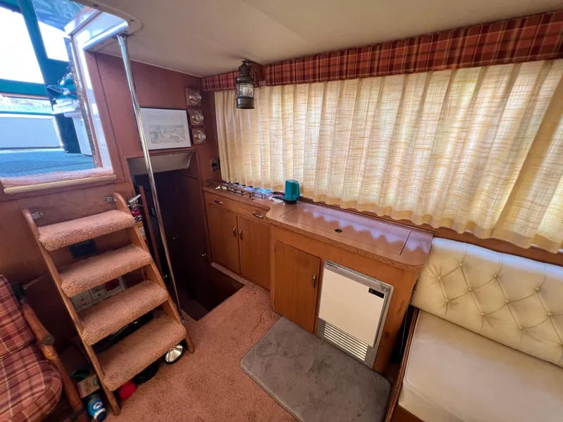 Slide: The Image of Interior of 1967 Hatteras 41 Twin Cabin with wood paneling and cozy seating area. - 30