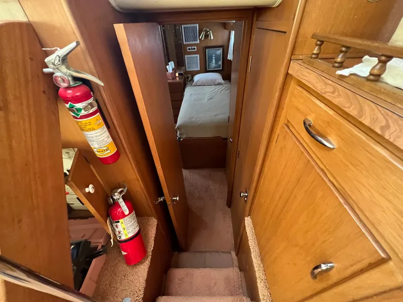 Slide: The Image of Interior of 1967 Hatteras 41 Twin Cabin with wooden cabinetry and fire extinguishers. - 31