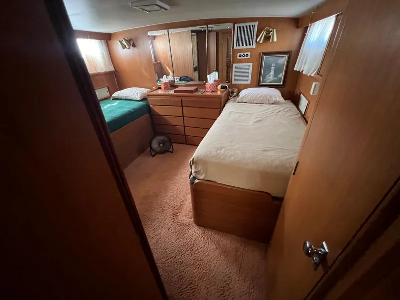 Slide: The Image of 1967 Hatteras 41 Twin Cabin interior with twin beds and wooden furnishings. - 32