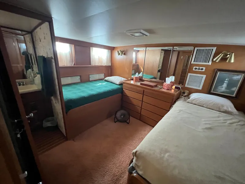 Slide: The Image of Interior of 1967 Hatteras 41 Twin Cabin with twin beds and wooden furnishings. - 33