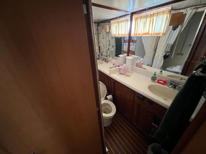 Slide: The Image of Bathroom interior of 1967 Hatteras 41 Twin Cabin yacht, featuring wood accents and nautical decor. - 34