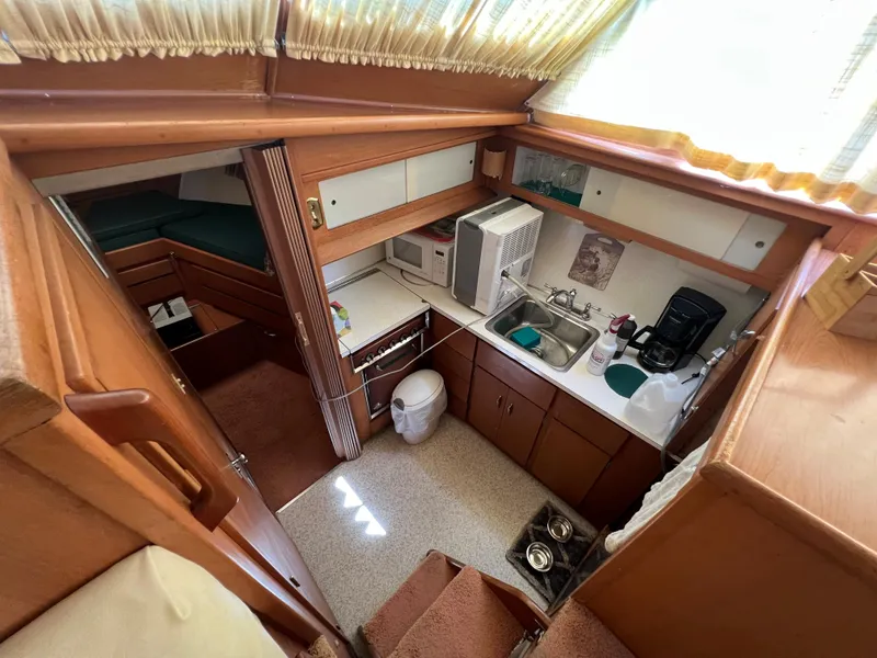 Slide: The Image of Interior of 1967 Hatteras 41 Twin Cabin with kitchen and cozy living space. - 37