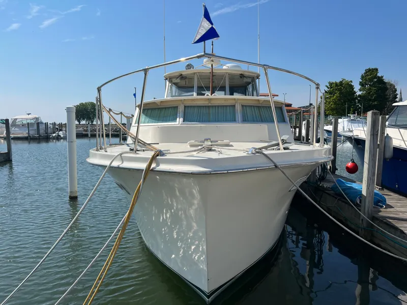 Slide: The Image of 1967 Hatteras 41 Twin Cabin yacht docked at marina, front view. - 4