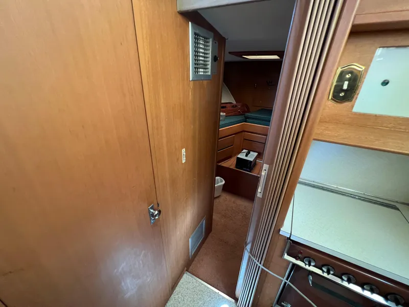 Slide: The Image of Interior of 1967 Hatteras 41 Twin Cabin, featuring wood paneling and compact layout. - 41