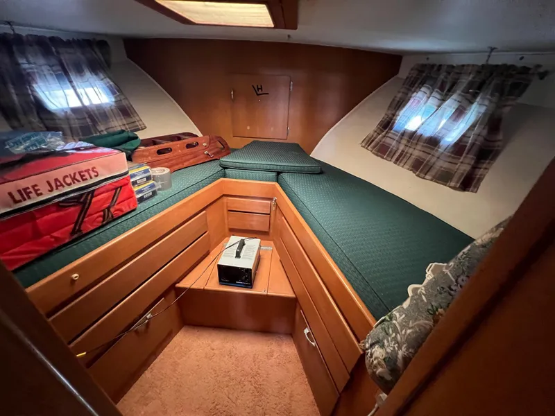 Slide: The Image of Cozy cabin interior of 1967 Hatteras 41 Twin Cabin with life jackets and plaid curtains. - 42