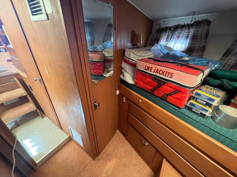 Slide: The Image of 1967 Hatteras 41 Twin Cabin interior with life jackets and storage. - 43