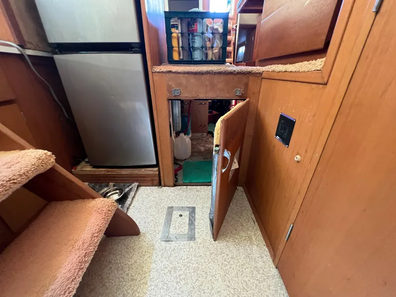 Slide: The Image of Interior of 1967 Hatteras 41 Twin Cabin with wooden cabinetry and compact storage. - 44