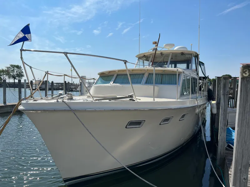 Slide: The Image of 1967 Hatteras 41 Twin Cabin yacht docked at marina under clear sky. - 5