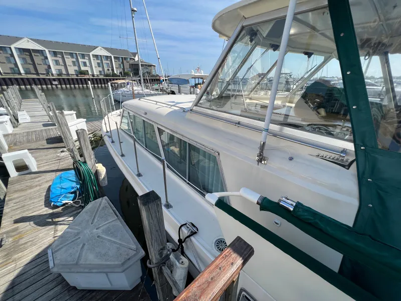 Slide: The Image of 1967 Hatteras 41 Twin Cabin yacht docked at marina with clear blue sky. - 8