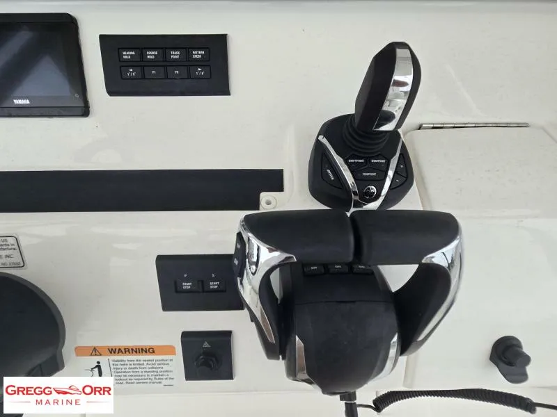 Slide: The Image of Control panel of 2025 Regulator 31 boat with joystick and throttle controls. - 11