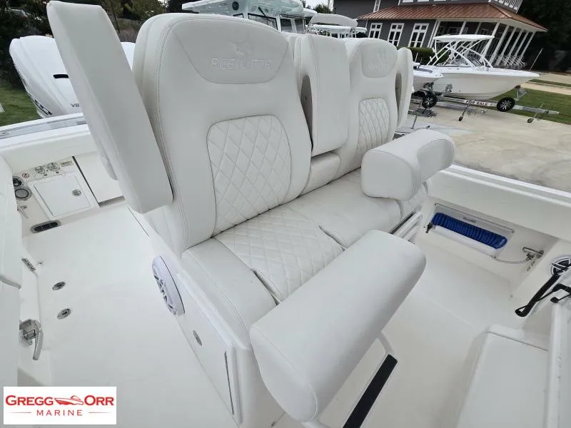 Slide: The Image of 2025 Regulator 31 boat with luxurious white seating and diamond stitching detail. - 12