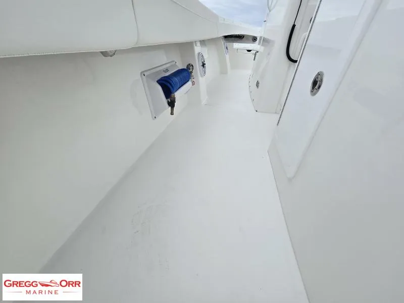 Slide: The Image of 2025 Regulator 31 boat interior with clean white deck and storage compartments. - 13
