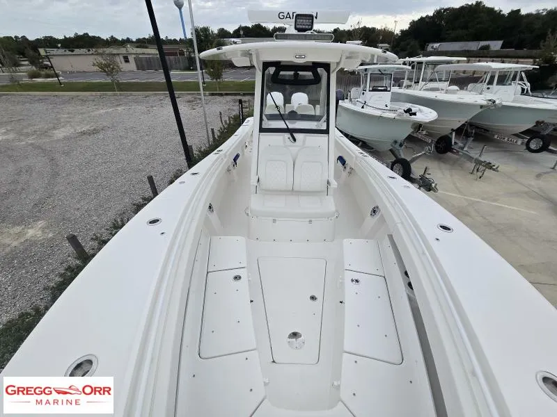Slide: The Image of 2025 Regulator 31 boat, white interior, parked at Gregg Orr Marine dealership. - 15