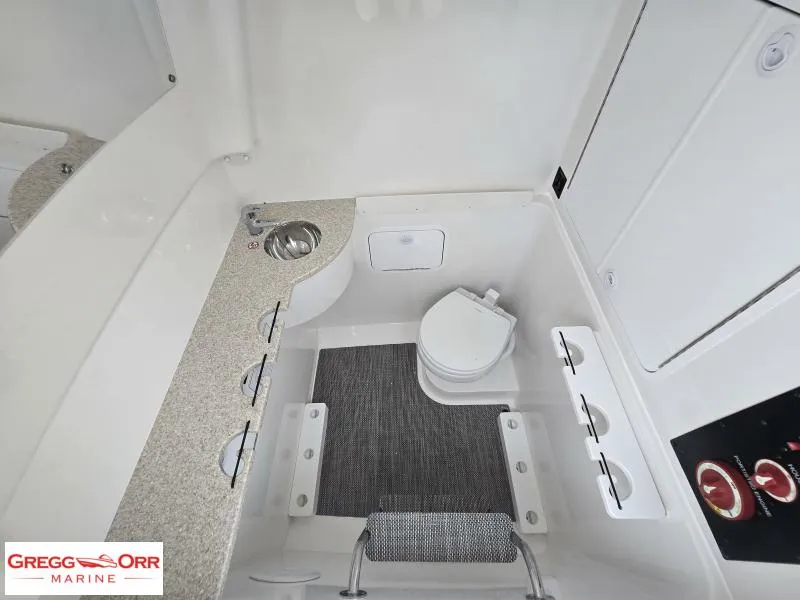 Slide: The Image of 2025 Regulator 31 boat interior with compact bathroom, sink, and storage. - 19