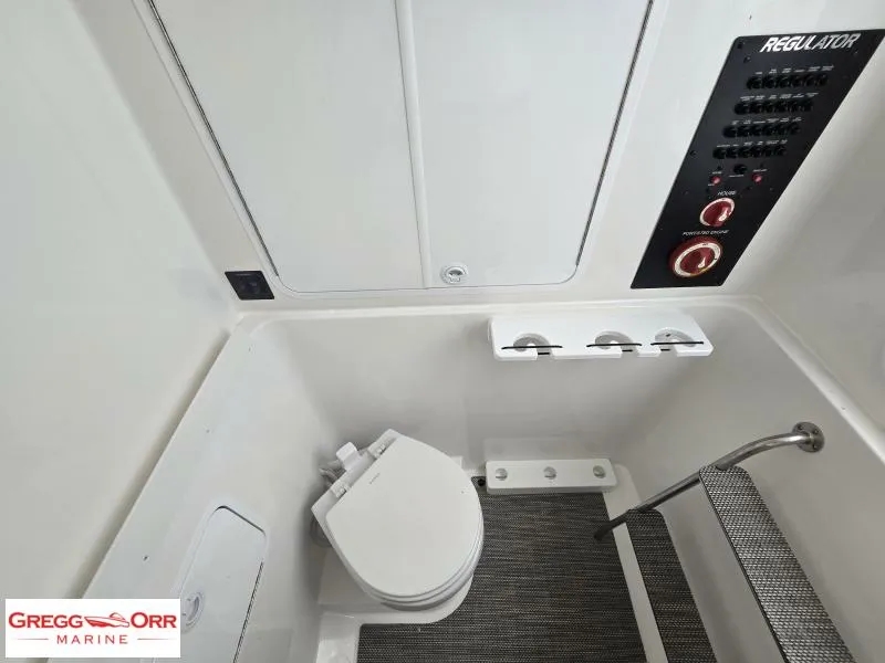 Slide: The Image of 2025 Regulator 31 boat interior with toilet and control panel. - 20