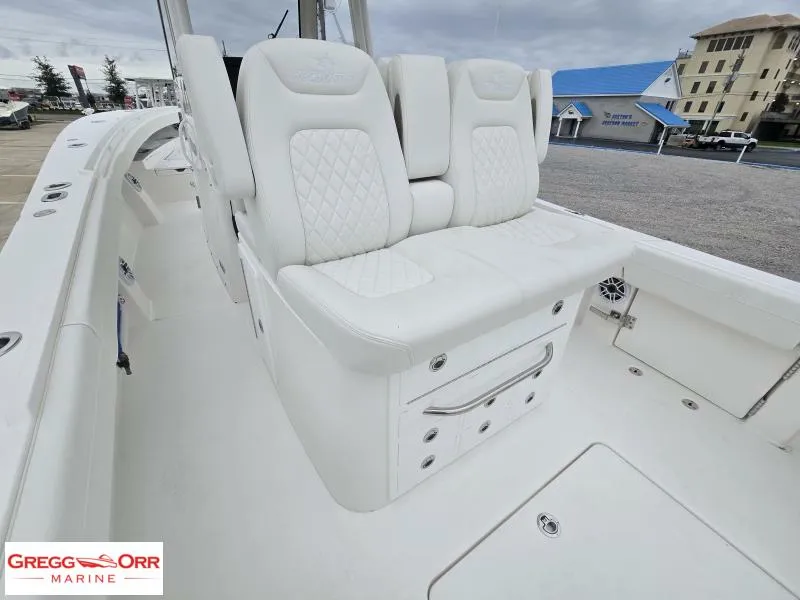 Slide: The Image of 2025 Regulator 31 boat with white cushioned seating and storage, displayed at Gregg Orr Marine. - 9