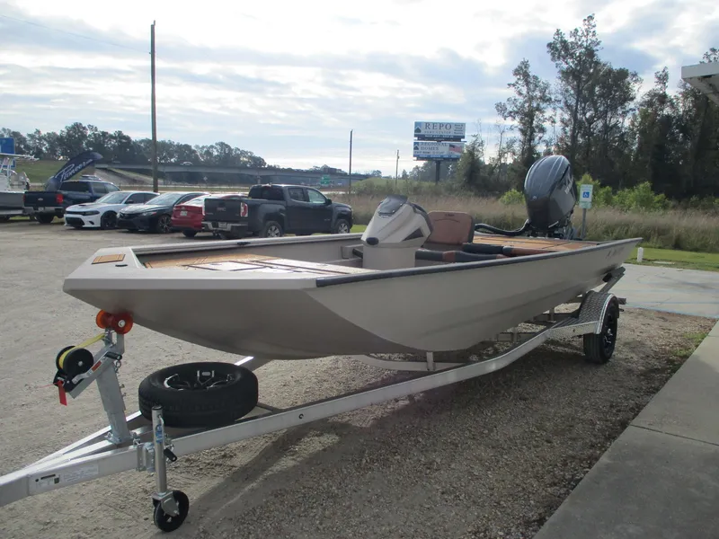 Slide: The Image of 2025 Avid Rogue 20 SC boat on trailer in parking lot. - 2
