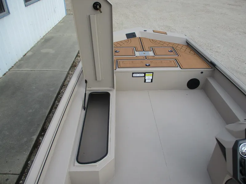 Slide: The Image of 2025 Avid Rogue 20 SC boat interior with storage compartments and non-slip flooring. - 8