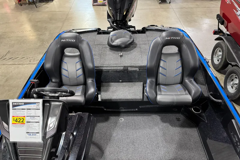 Slide: The Image of 2023 Nitro Z18 boat interior with dual seats and steering wheel, displayed in showroom. - 10