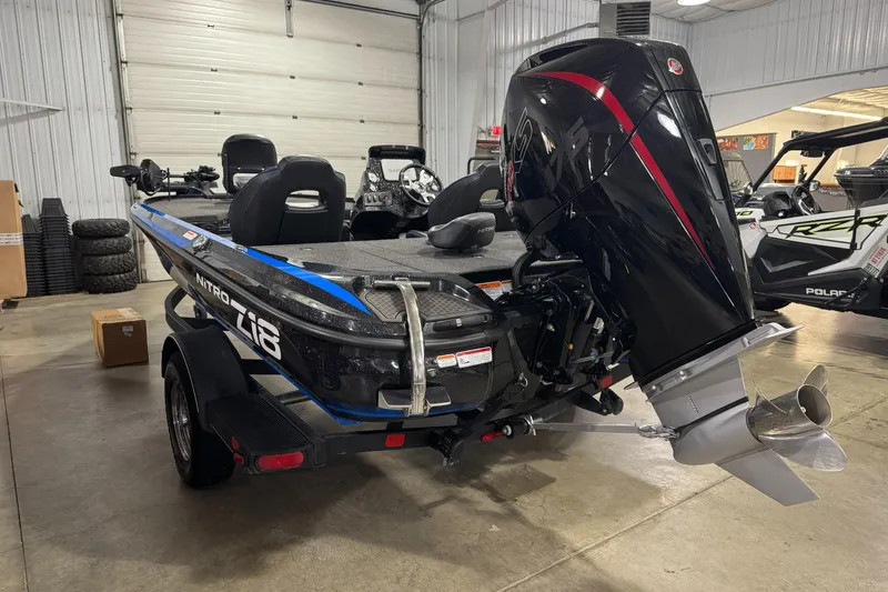 Slide: The Image of 2023 Nitro Z18 boat in showroom, featuring powerful outboard motor. - 3