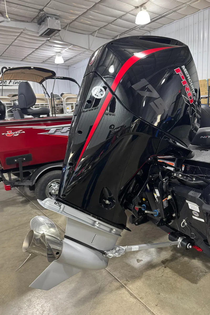 Slide: The Image of 2023 Nitro Z18 boat engine in showroom, featuring sleek black and red design. - 4