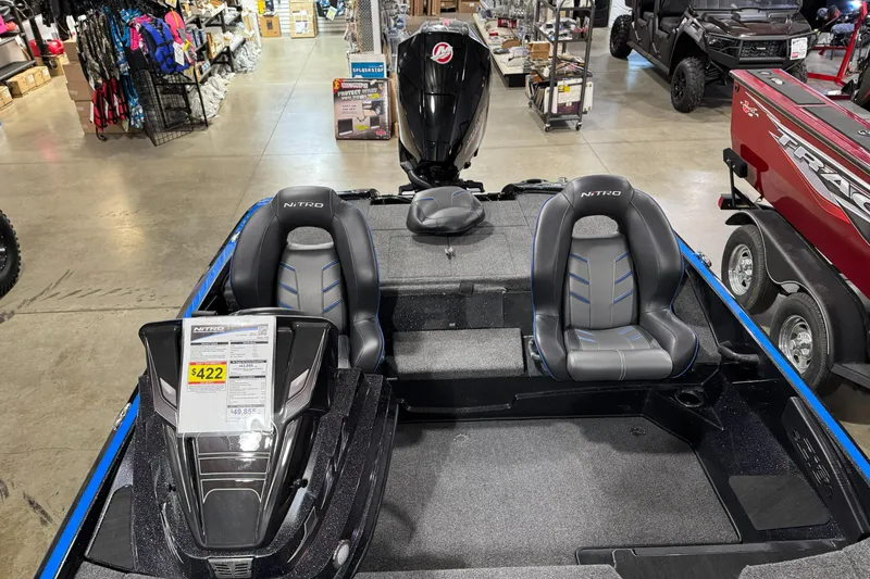 Slide: The Image of 2023 Nitro Z18 boat interior with seats and motor in showroom. - 6
