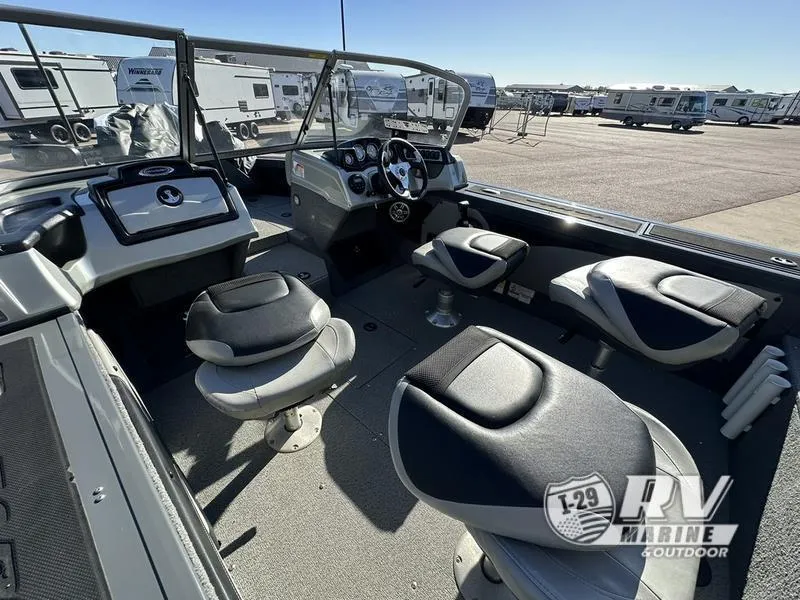 Slide: The Image of Interior of 2018 Targa 19 boat with seating and dashboard, parked near RVs. - 5