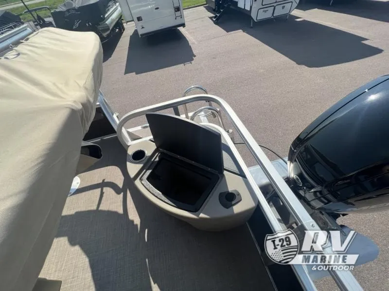 Slide: The Image of 2023 Sportfish 20 DLX boat with open storage compartment and motor, displayed at RV Marine. - 11