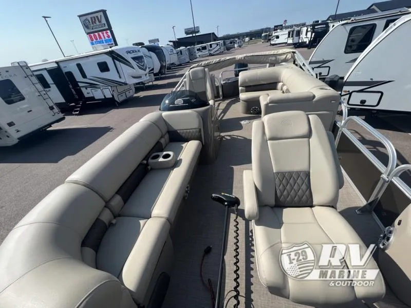Slide: The Image of 2023 Sportfish 20 DLX pontoon boat with luxurious seating at RV Marine dealership. - 16