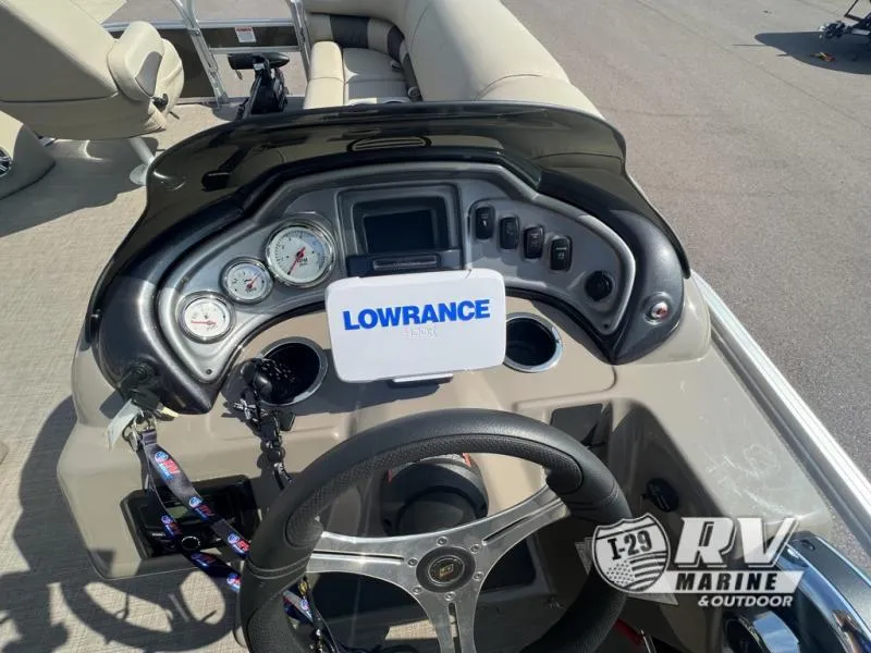 Slide: The Image of 2023 Sportfish 20 DLX boat dashboard with Lowrance electronics and steering wheel. - 4