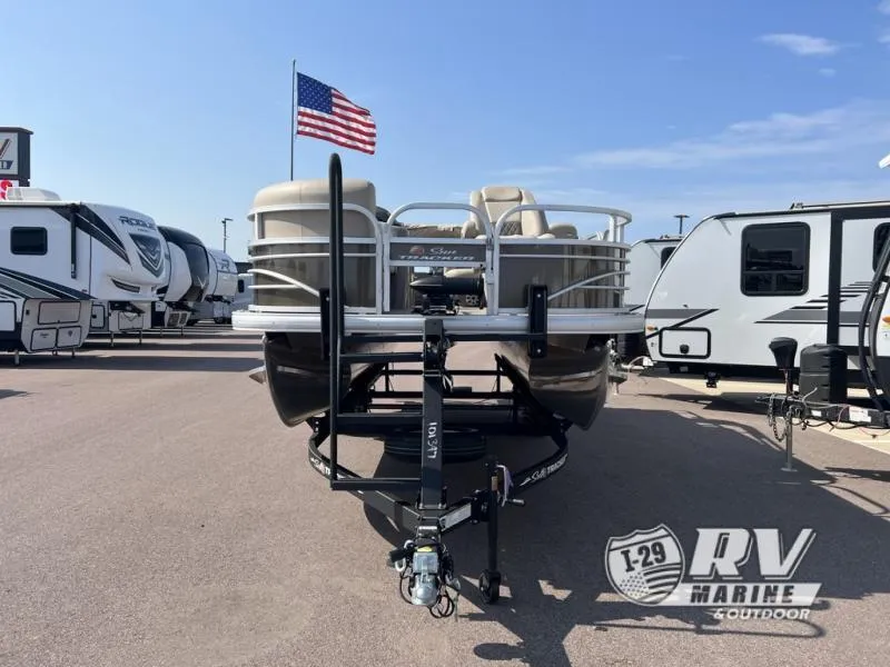 Slide: The Image of 2023 Sportfish 20 DLX pontoon boat on trailer at RV dealership, American flag in background. - 5