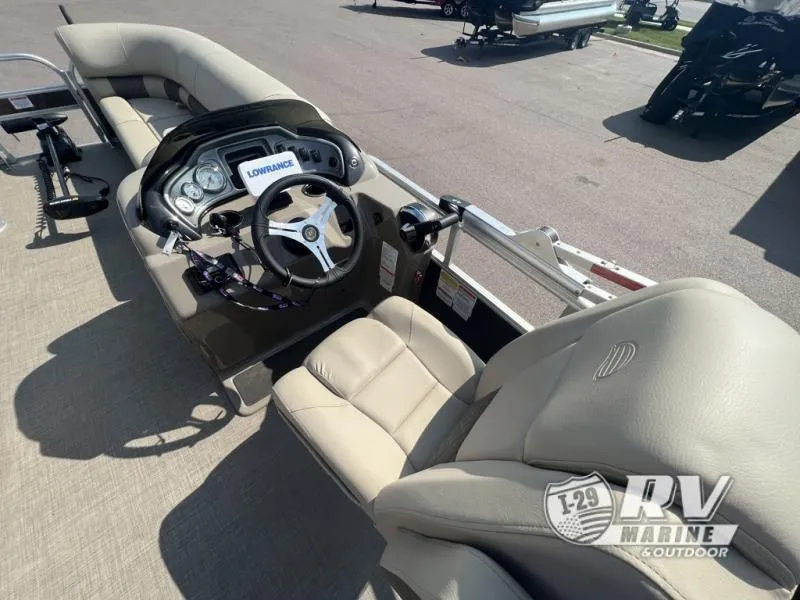 Slide: The Image of 2023 Sportfish 20 DLX boat interior with steering console and beige seating. - 7