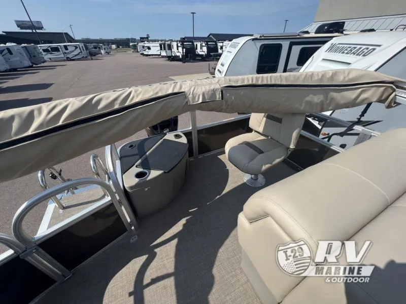 Slide: The Image of 2023 Sportfish 20 DLX boat interior with beige seating and covered canopy. - 8