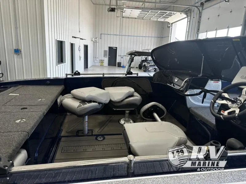 Slide: The Image of 2024 White River ZV19 boat interior with seating and steering wheel in a showroom. - 14