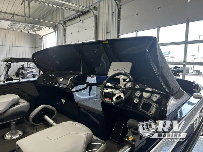 Slide: The Image of 2024 White River ZV19 boat interior with Garmin navigation, displayed in a showroom. - 2
